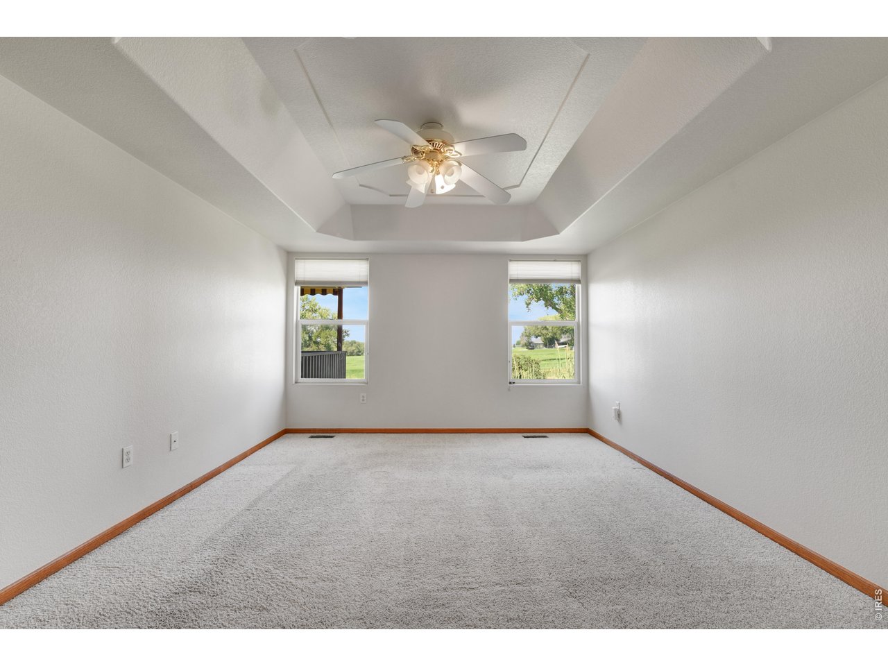 Property Photo 11 Primary bedroom - windows look west to golf course