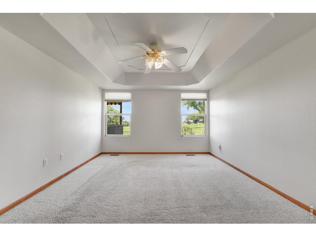 Property Photo 11 Primary bedroom - windows look west to golf course