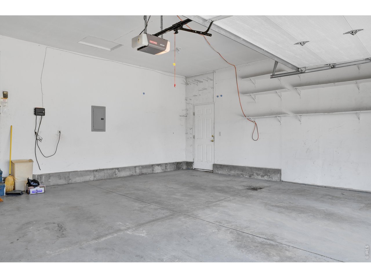 Property Photo 27 garage with shelves and side door entrance