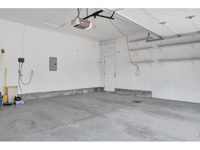 Property Photo 27 garage with shelves and side door entrance