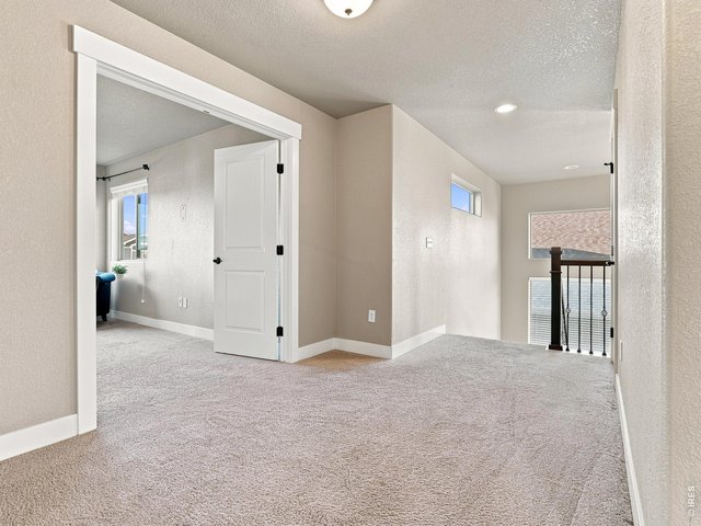 Property Photo 23 Open upper-level landing with additional storage and linen closet.