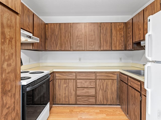 Property Photo 7 Unit 1: Kitchen has electric range/oven and refrigerator