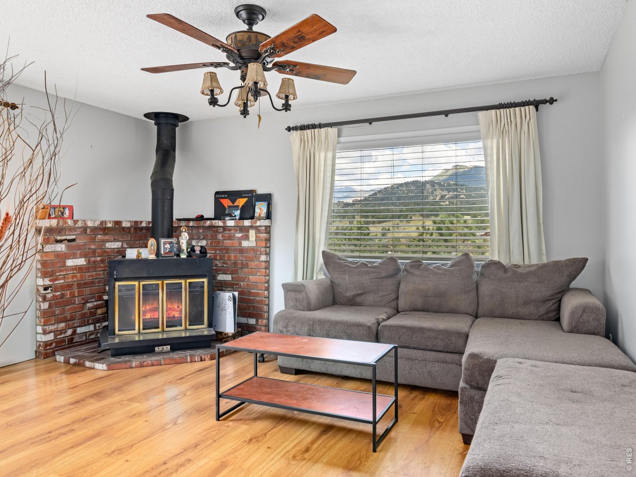 Property Photo 18 Unit 3: Upper level unit, living room with wood burning fireplace and mountain views