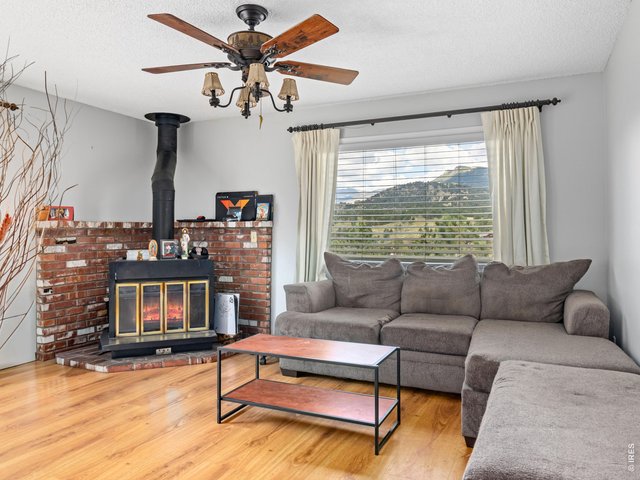 Property Photo 18 Unit 3: Upper level unit, living room with wood burning fireplace and mountain views