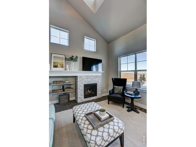 Property Photo 5 The vaulted ceiling in the living room lets in an abundance of natural light