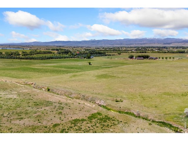 Property Photo 5 The property features expansive, unobstructed views of the Front Range and surrounding foothills, with gently rolling, highly usable terrain and established agricultural ground that has historically supported solid hay production.