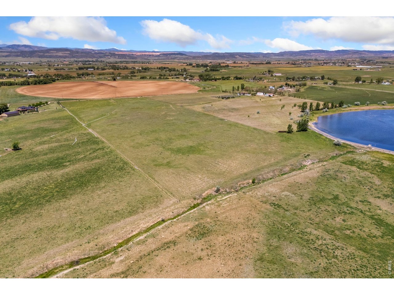 Property Photo 6 The property features expansive, unobstructed views of the Front Range and surrounding foothills, with gently rolling, highly usable terrain and established agricultural ground that has historically supported solid hay production.