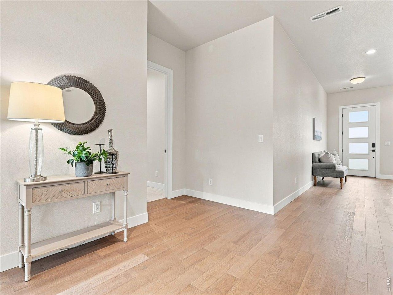 Property Photo 17 Spacious foyer with engineered hardwood flooring and modern finishes welcomes guests.