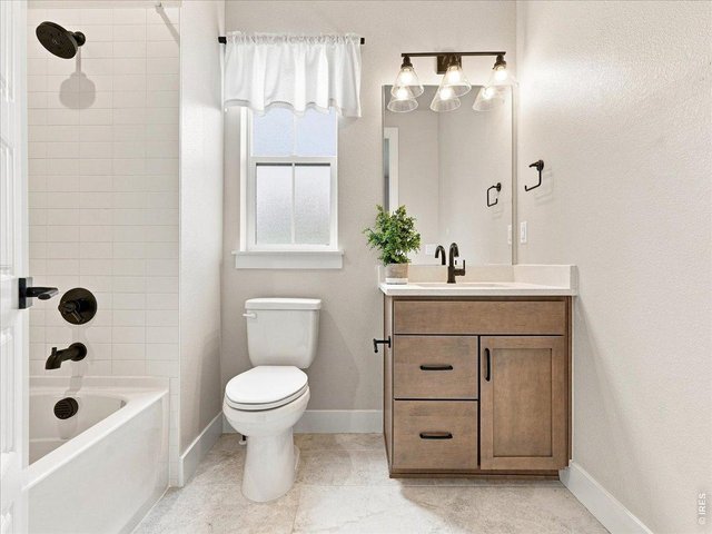 Property Photo 38 Upstairs bathroom continues the home's upscale finishes with quartz and matte black fixtures.