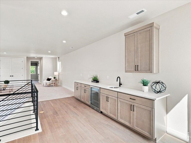 Property Photo 36 Wet bar with beverage refrigerator makes entertaining effortless.