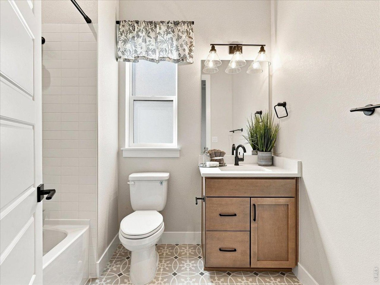 Property Photo 28 Main level, secondary bathroom continues the home's upscale finishes with quartz and matte black fixtures.