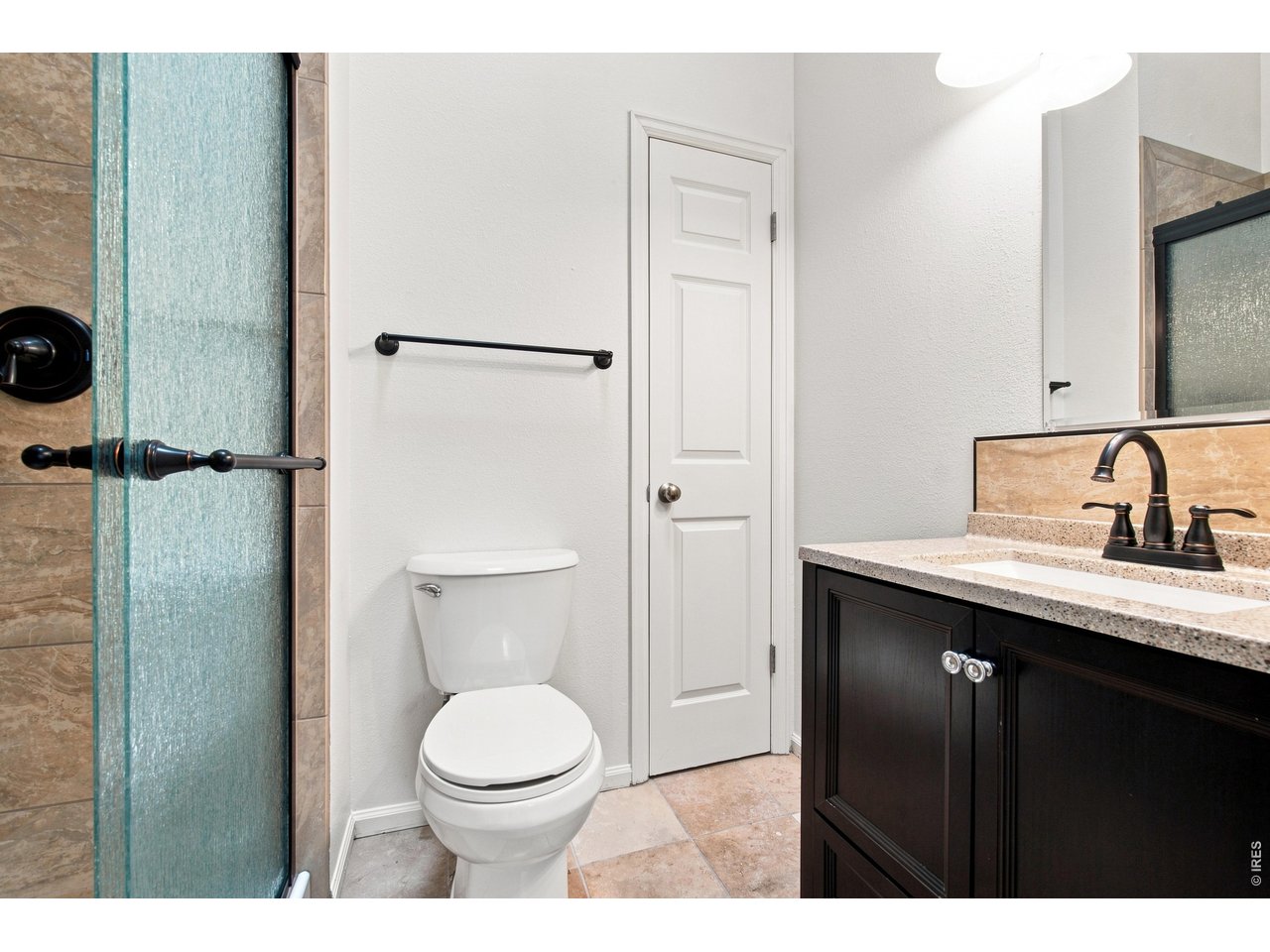 Property Photo 12 Updated bathroom featuring a contemporary vanity, modern fixtures and tiled shower with glass enclosure.