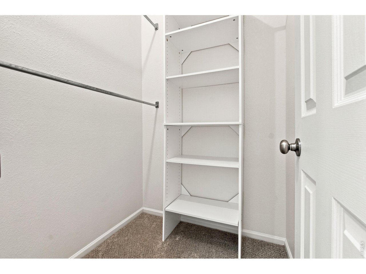 Property Photo 19 Generous walk-in closet with built-in shelving and plenty of storage.