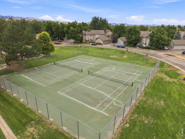 Property Photo 27 Community tennis courts surrounded by open green space and mountain views.