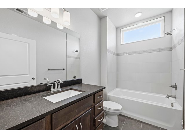 Property Photo 25 primary bath has tub shower combo with 12 x 24 inch tile