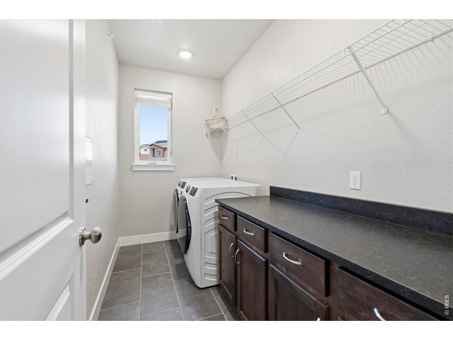 Property Photo 24 Laundry comes with washer , dryer and loads fof cabinetry