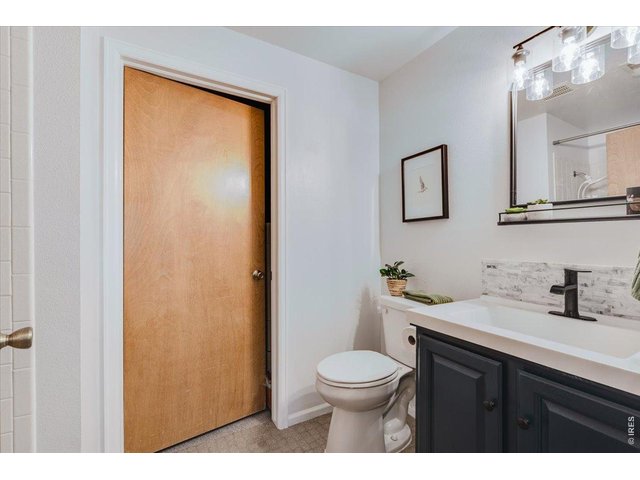 Property Photo 36 3rd bathroom is in the lower level with a shower, the door opens to the laundry/storage room