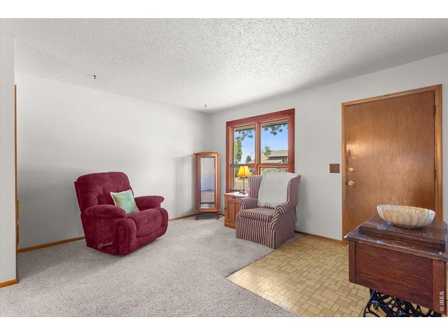 Property Photo 8 Hardwood under carpet in the living room, hallway and bedrooms.
