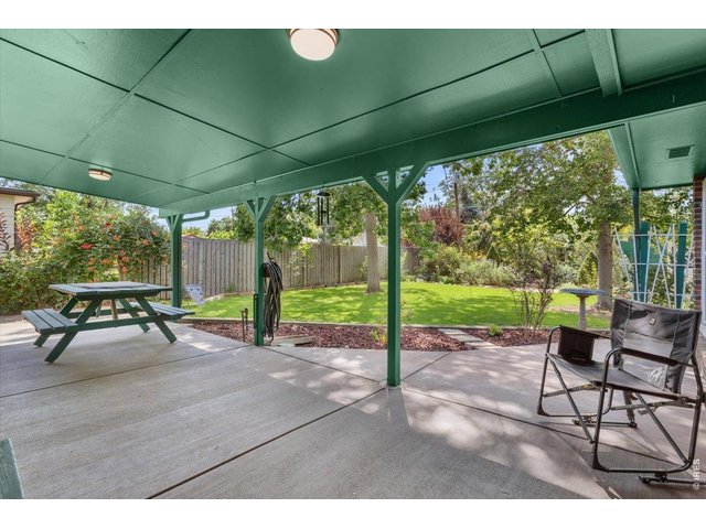 Property Photo 32 Spacious covered patio, from which to enjoy the lush, quiet, shaded beauty of the back yard.