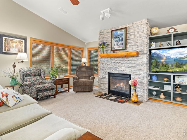 Property Photo 14 Stacked-stone fireplace in the greatroom