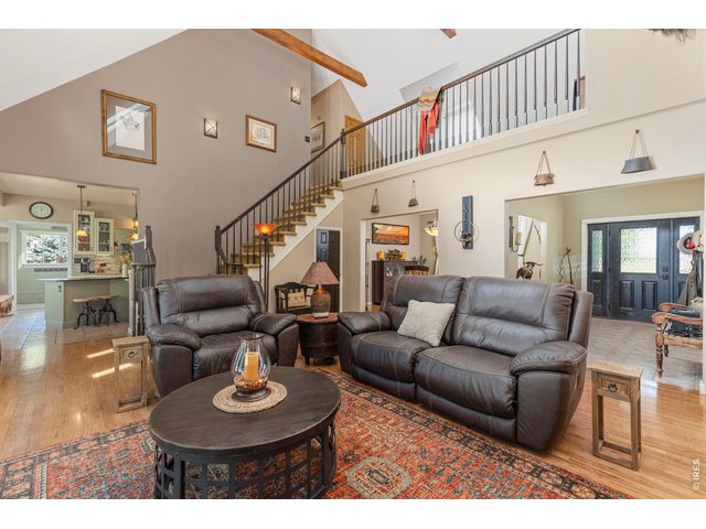Property Photo 32 The open living area features soaring ceilings, wood floors and an upper-level overlook.