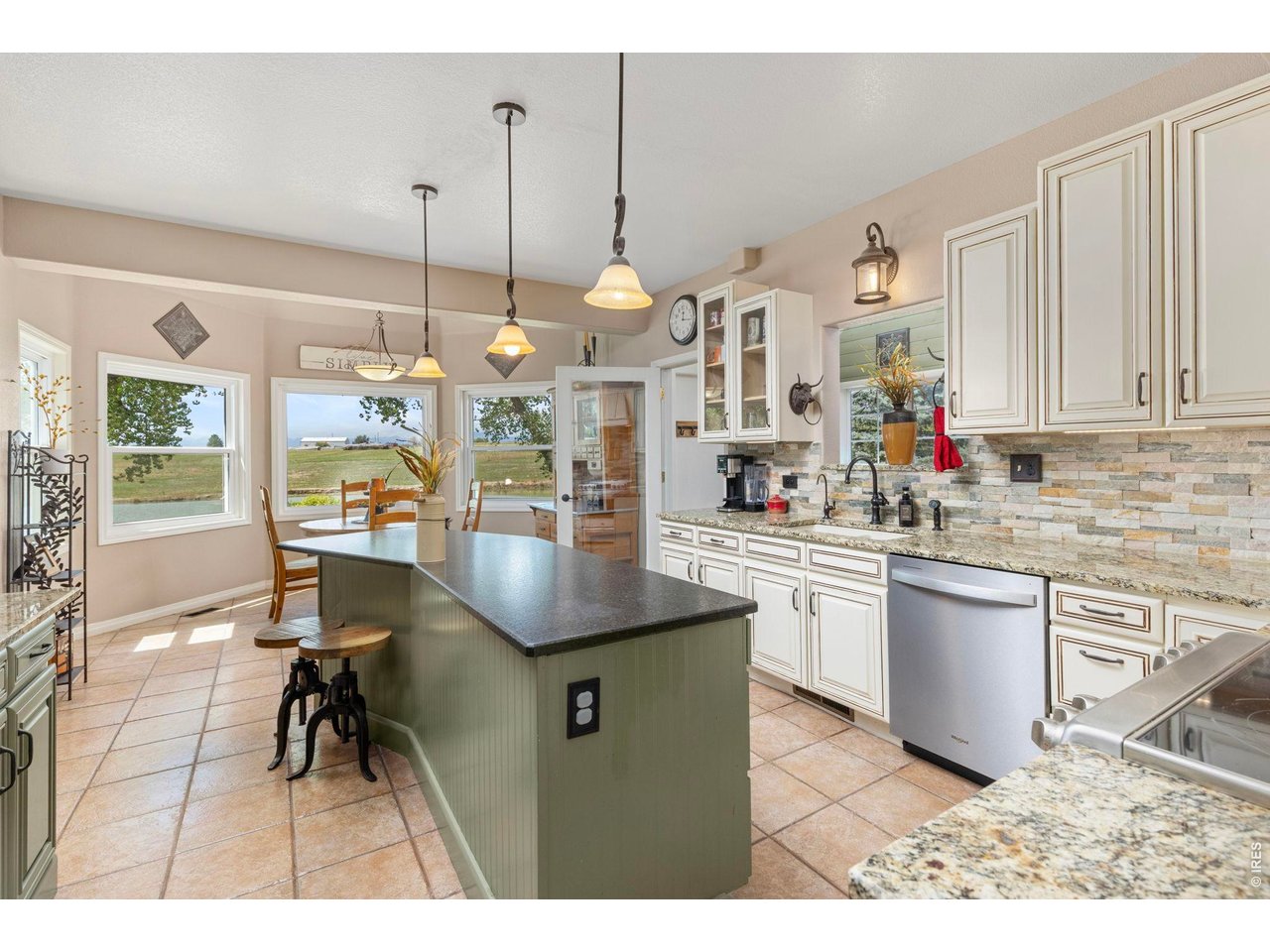 Property Photo 35 Generous kitchen with center island, granite surfaces and abundant cabinetry.
