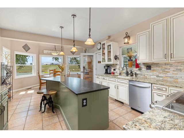 Property Photo 35 Generous kitchen with center island, granite surfaces and abundant cabinetry.