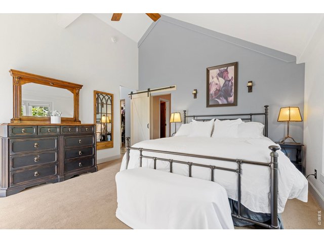 Property Photo 39 Main-level primary bedroom with vaulted ceiling.