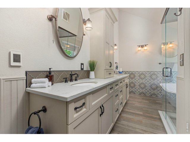 Property Photo 40 Updated primary bath with extensive cabinetry and walk-in shower.