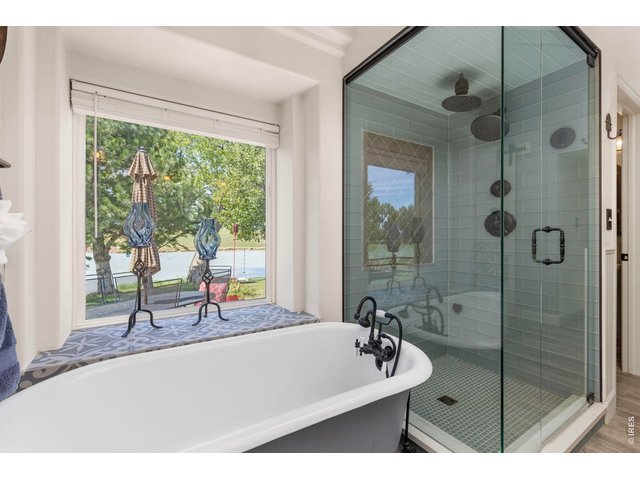 Property Photo 41 Freestanding soaking tub and oversized shower, with Little Gem Reservoir just beyond the window.
