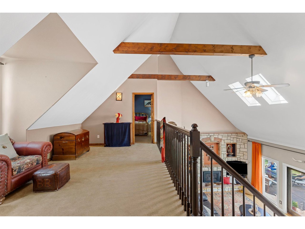Property Photo 44 Upper-level loft provides access to three additional bedrooms and overlooks the main living area below.