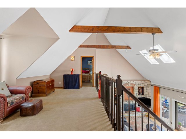 Property Photo 44 Upper-level loft provides access to three additional bedrooms and overlooks the main living area below.