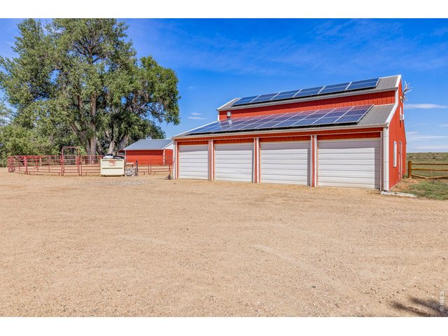 Property Photo 24 1,920 sq. ft. four-bay shop/detached garage with solar and additional living space above.