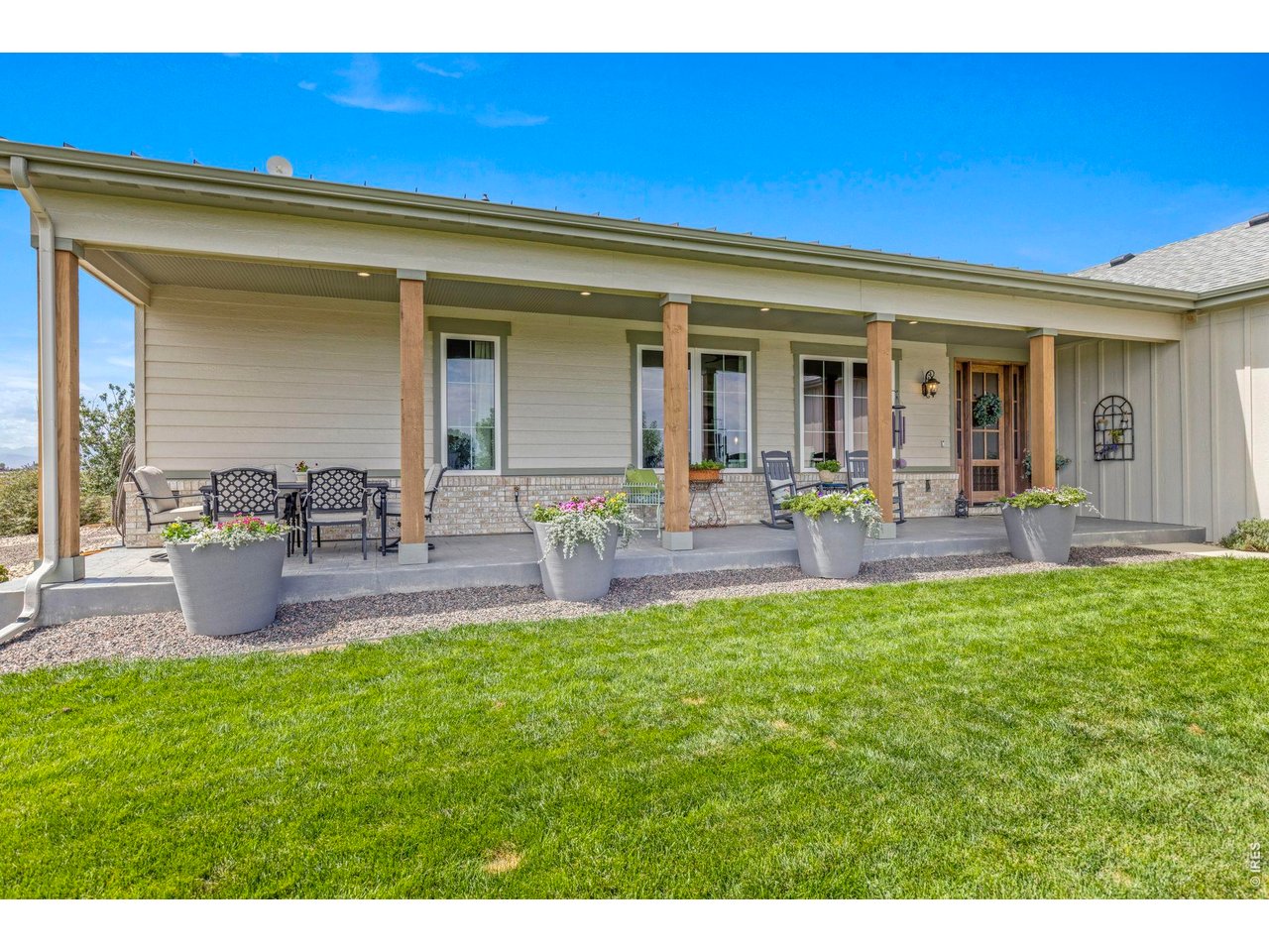 Property Photo 6 Covered front porch creates an inviting outdoor living space at the 2023 residence.