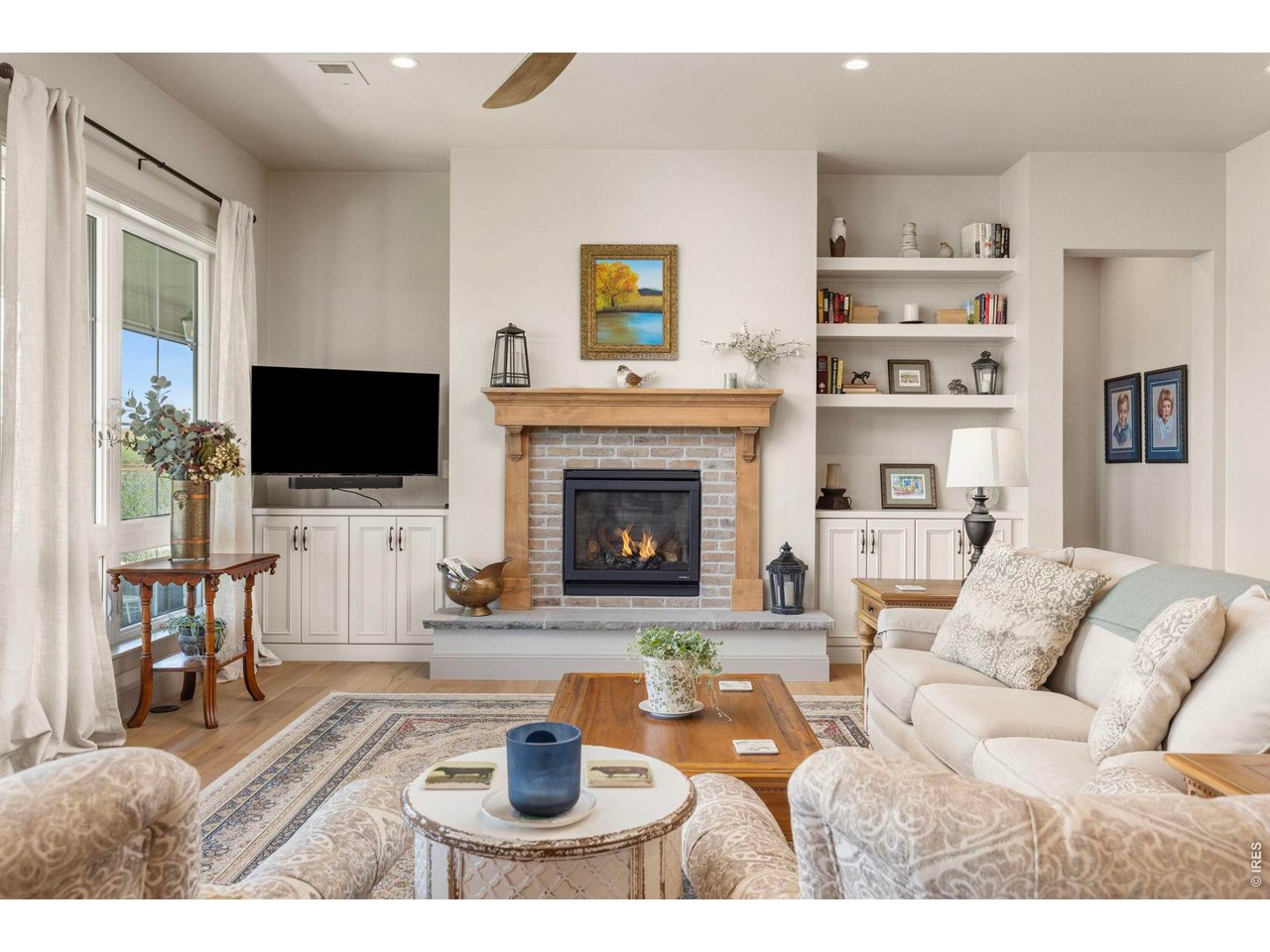 Property Photo 12 Gas fireplace with custom built-ins creates a comfortable focal point within the main living area.