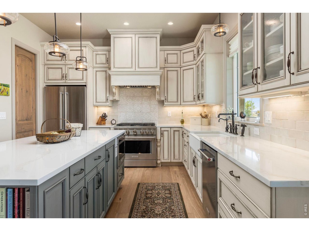 Property Photo 14 Beautifully appointed kitchen with extensive cabinetry, quartz surfaces and a professional-style range.