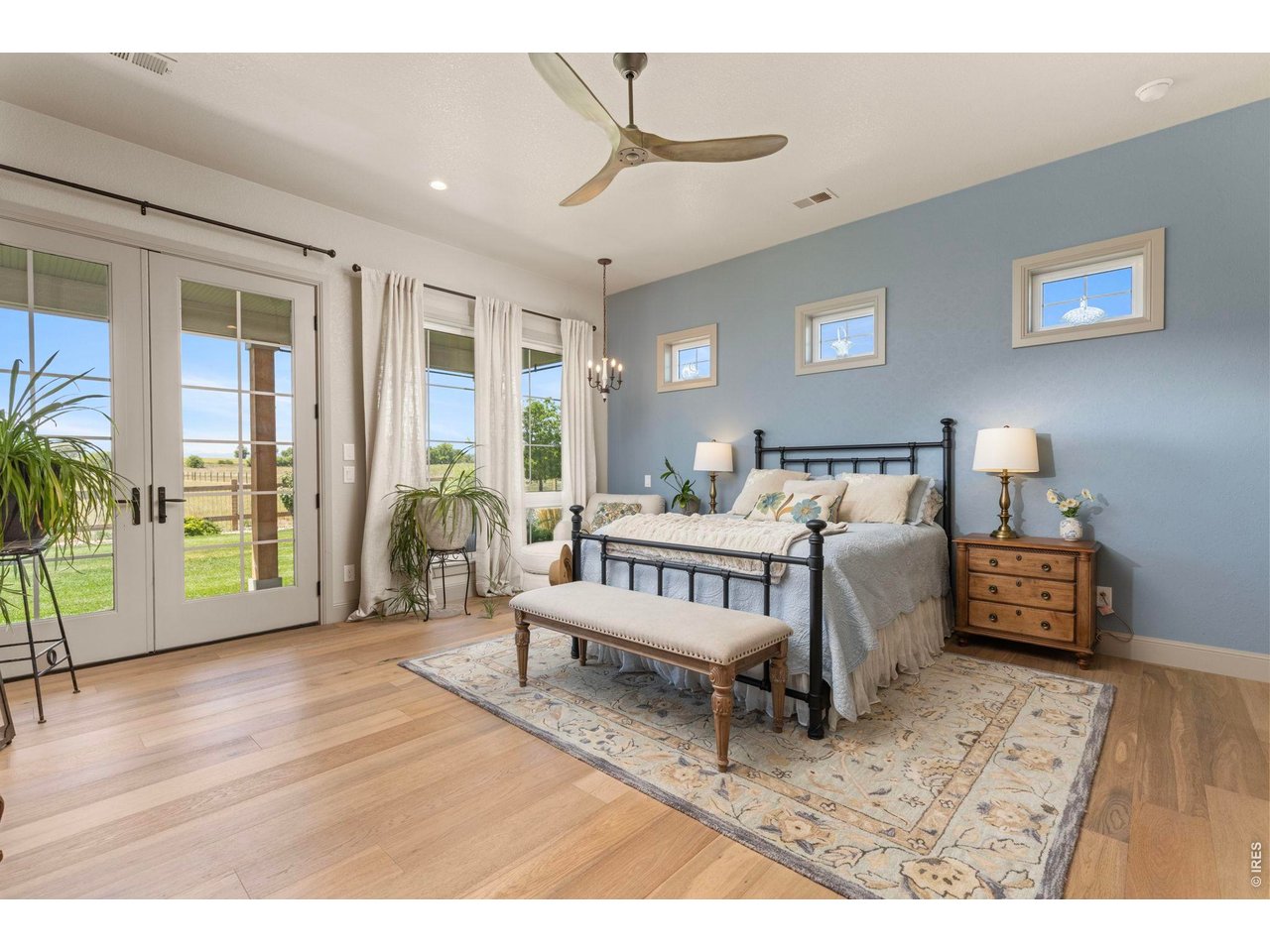 Property Photo 16 Primary bedroom with direct outdoor access, abundant natural light and views across the acreage.