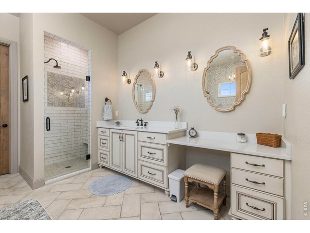 Property Photo 17 Primary bath with extensive cabinetry, dual vanities and a spacious walk-in shower.