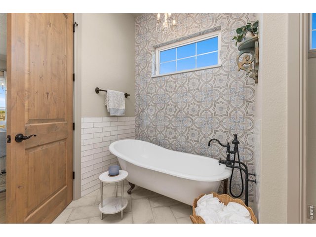 Property Photo 18 Freestanding soaking tub adds character to the beautifully finished primary bath.