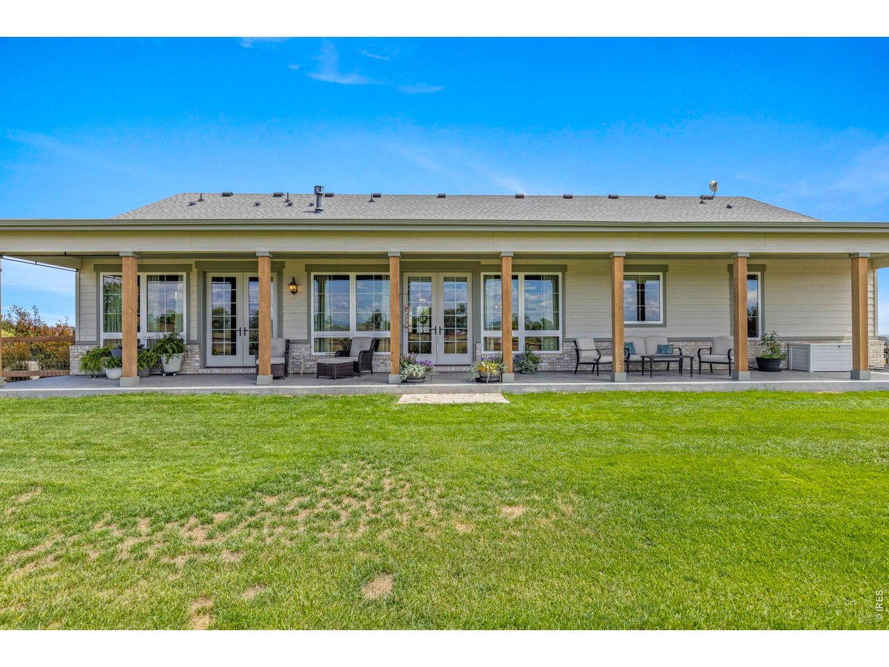 Property Photo 21 Expansive covered patio extends across the rear of the 2023 residence for exceptional outdoor living.