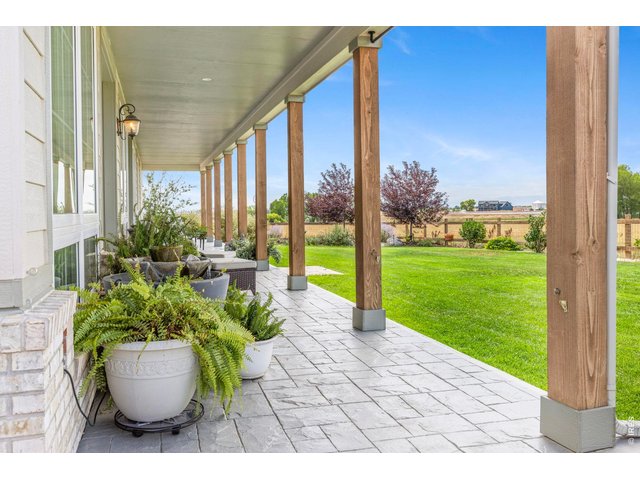 Property Photo 22 Covered outdoor living space overlooks the landscaped yard and surrounding acreage.