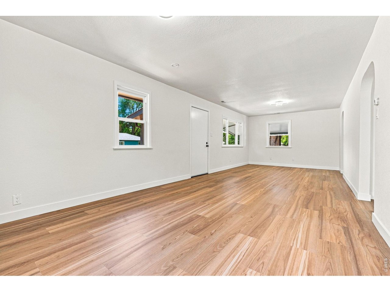 Property Photo 9 Spacious living room and dining area feature laminate wood flooring and plenty of natural light