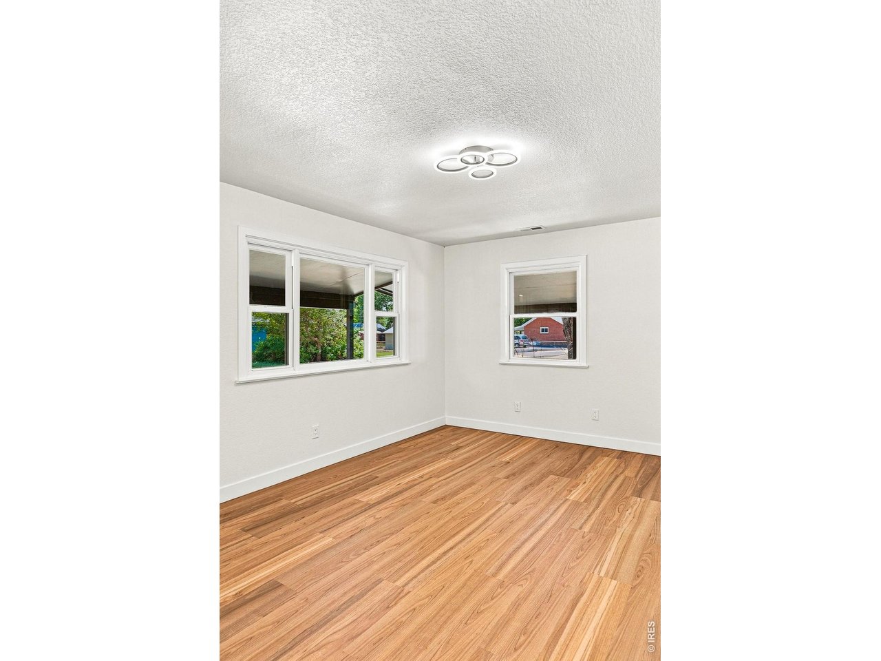 Property Photo 10 Spacious living room and dining area feature laminate wood flooring and plenty of natural light