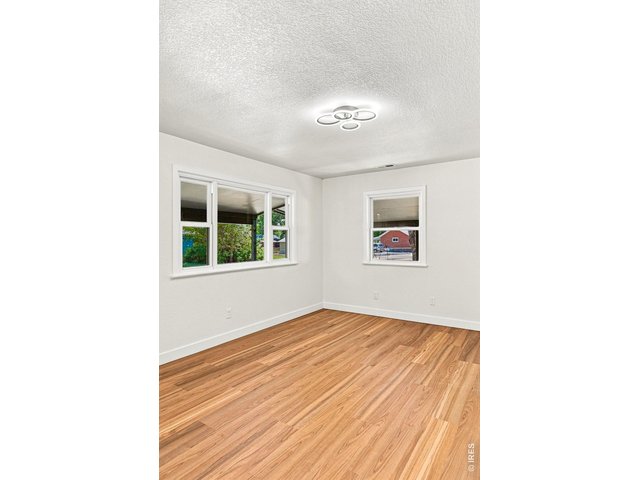 Property Photo 10 Spacious living room and dining area feature laminate wood flooring and plenty of natural light