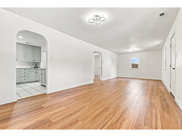 Property Photo 12 Spacious living room and dining area feature laminate wood flooring and plenty of natural light