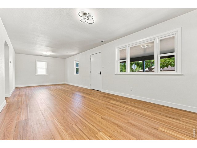 Property Photo 13 Spacious living room and dining area feature laminate wood flooring and plenty of natural light