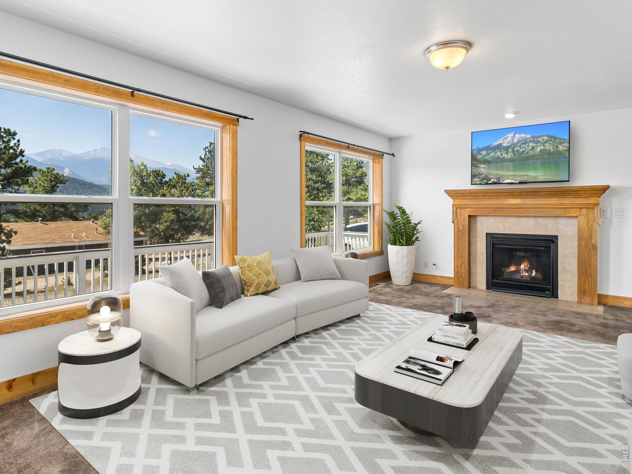 Property Photo 5 Living room has lots of windows to enjoy that stunning view all year round and gas burning fireplace.