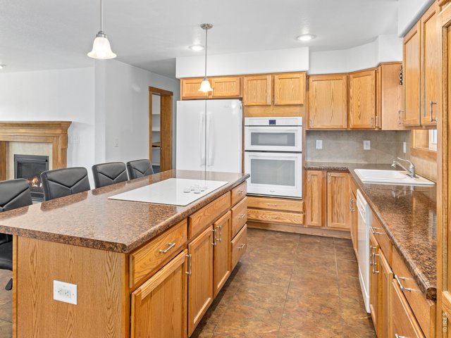 Property Photo 8 Large kitchen island with electric cook top and built in oven and microwave.