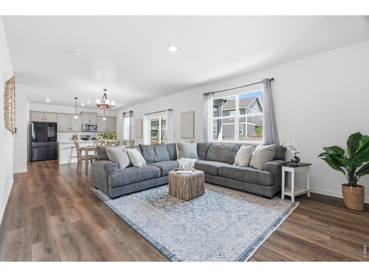 Property Photo 4 Bright open-concept main floor with luxury vinyl plank flooring and a sliding door to the backyard.