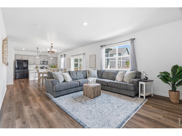 Property Photo 4 Bright open-concept main floor with luxury vinyl plank flooring and a sliding door to the backyard.